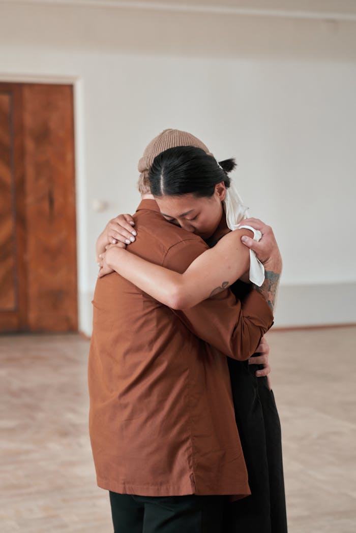 Two adults embracing warmly indoors, conveying deep affection and togetherness.
